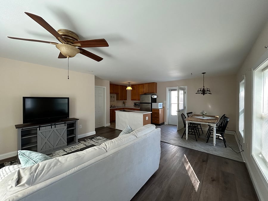 Living room, kitchen, dining area and door leading to bedroom. Exterior door leading to terrace.