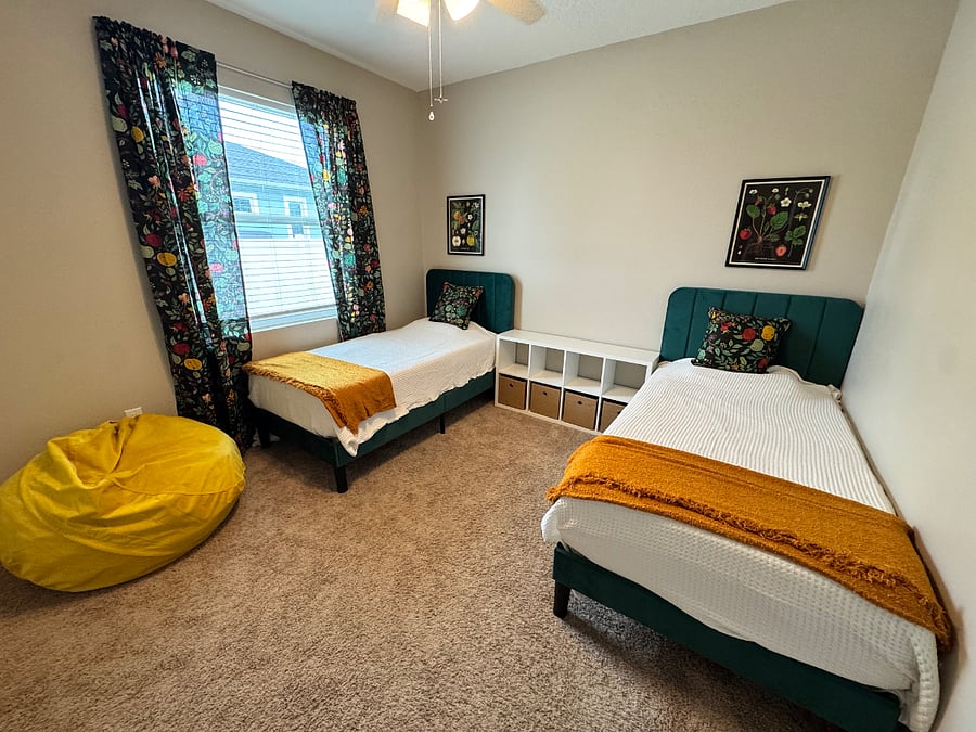 Bedroom 3. Two twin beds, pack and play, toys. 