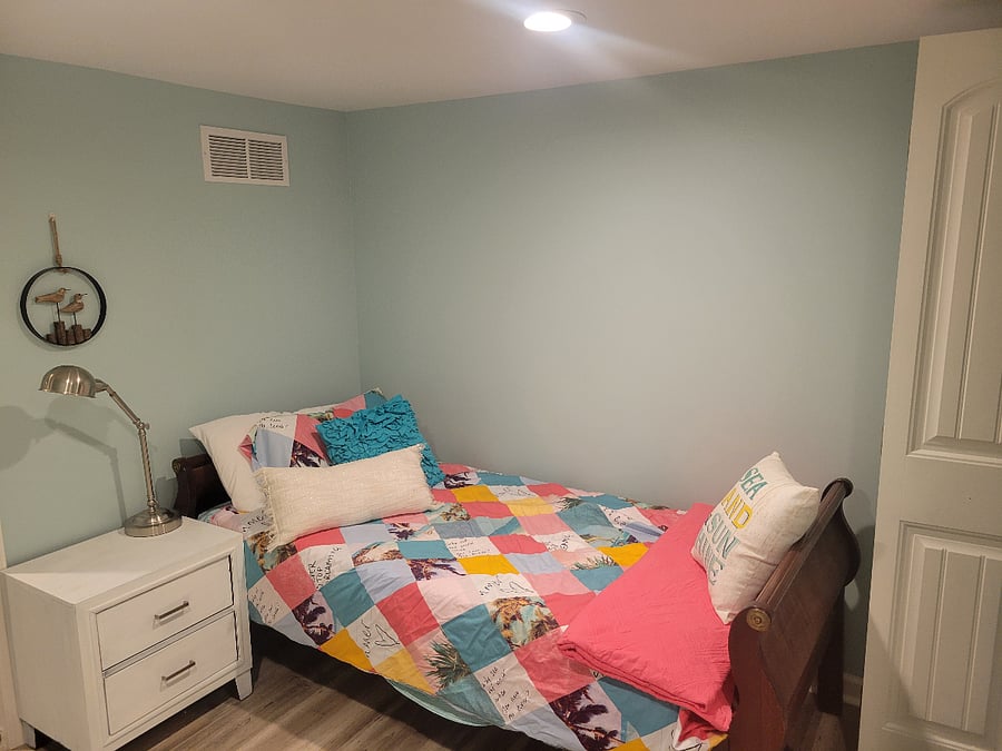 twin bed and nightstand (basement bedroom)ba