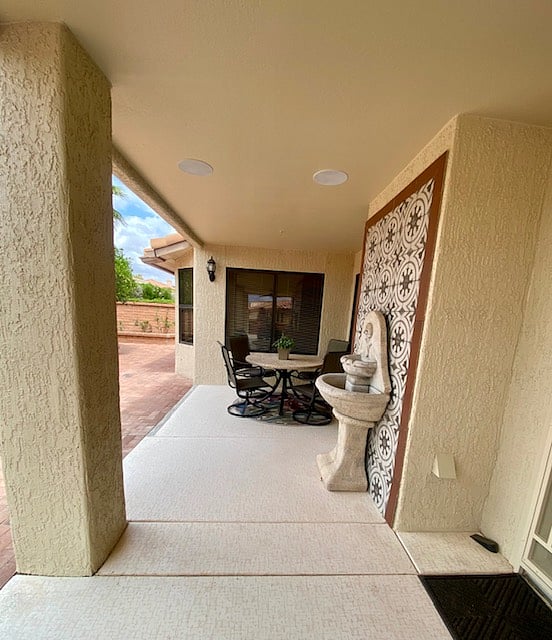 Outdoor dining area with Traeger grill and fountain