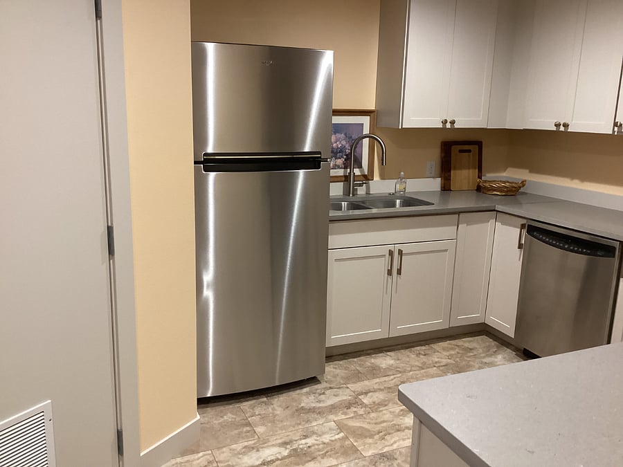 Double sink, dishwasher, and full-sized refrigerator.
