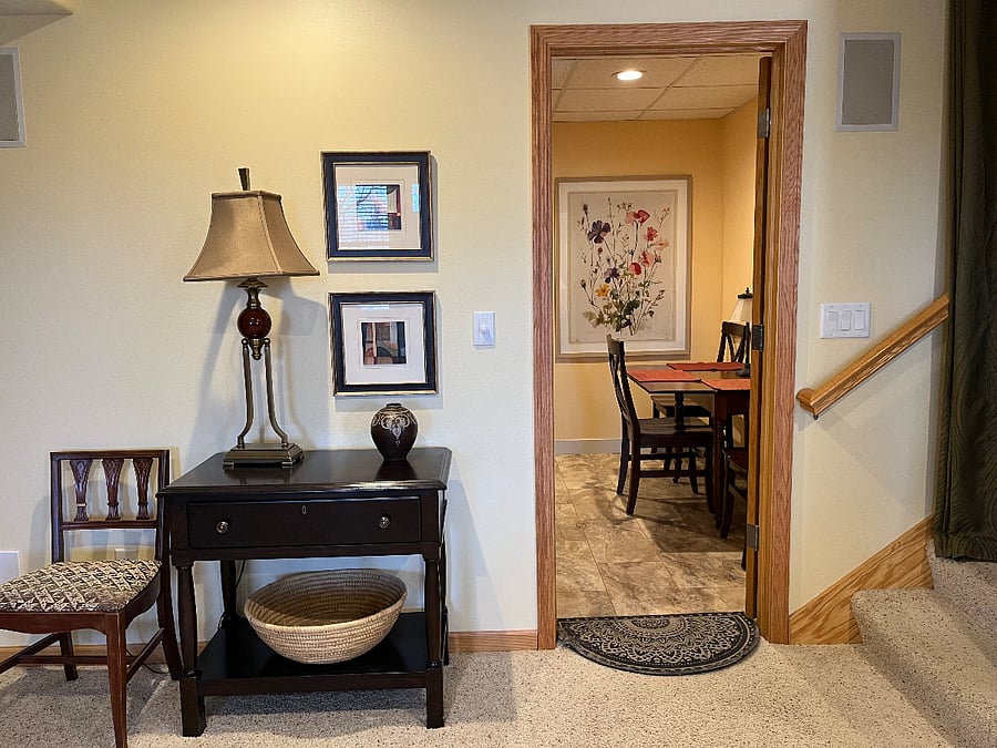Looking into the kitchen from the living room, and staircase entrance from the garage.