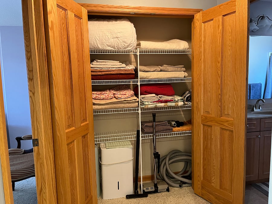 Linen closet between the main bedroom and bathroom.