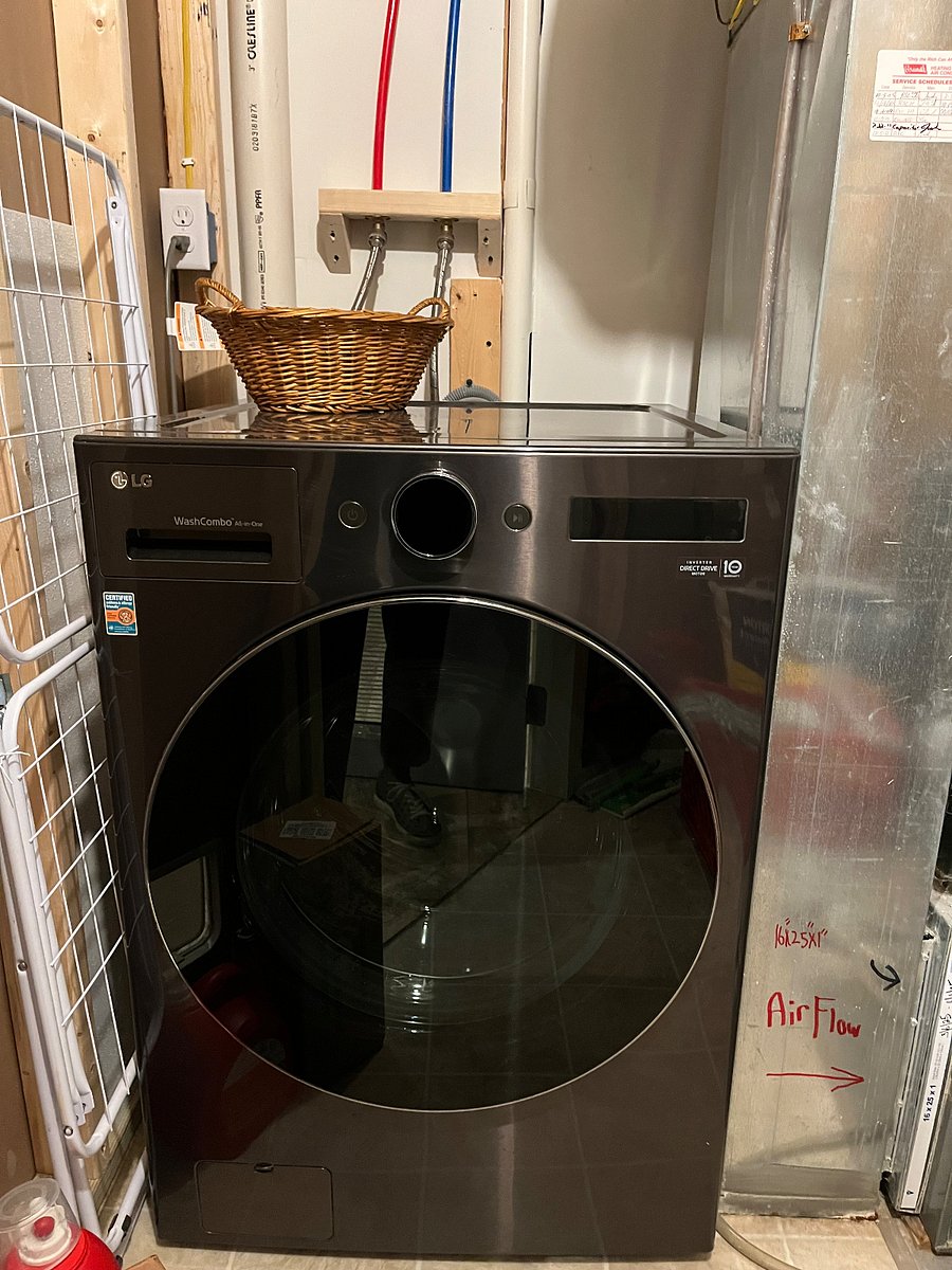 Combination washer/dryer located in utility closet within the kitchen.