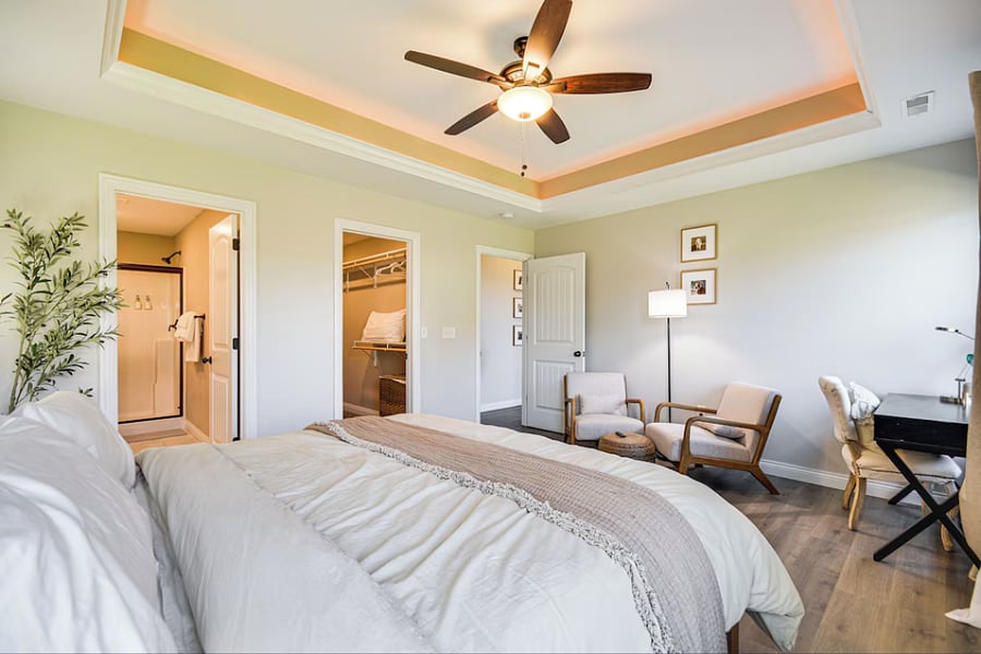 Features en suite bath, walk-in closet, desk, reading chair, and blackout curtains for restful nights or productive days.