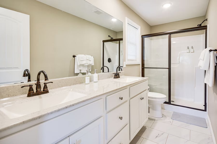 Bright, clean bathroom with walk-in shower and complimentary vegan toiletries.