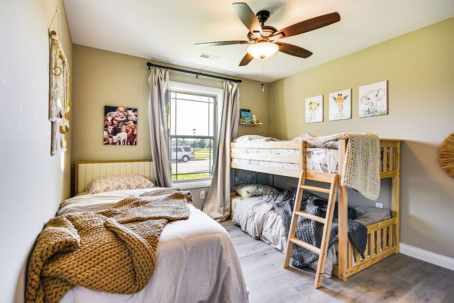 Twin bed plus bunk bed setup with open floor space for play and learning. Large closet for toys and clothes.