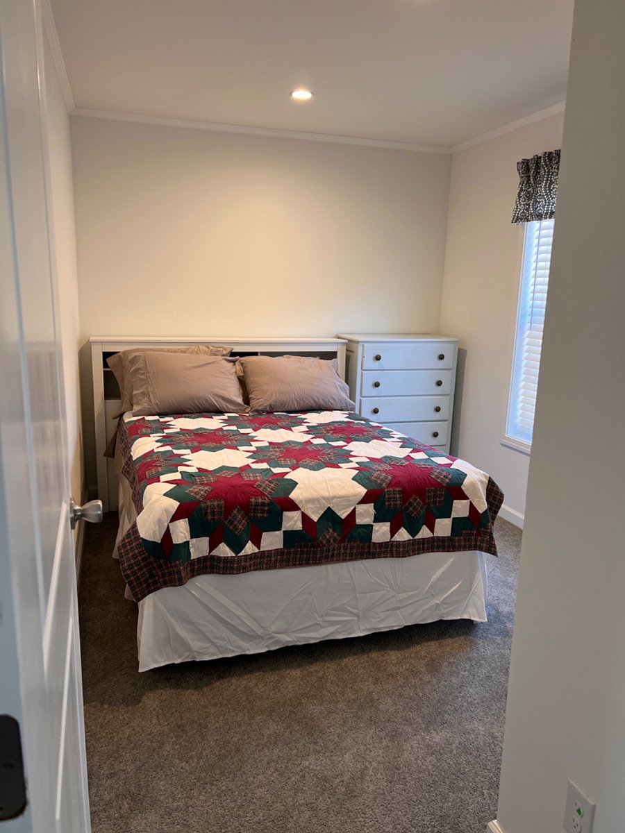 Bedroom 2 with full bed, dresser, and closet.
