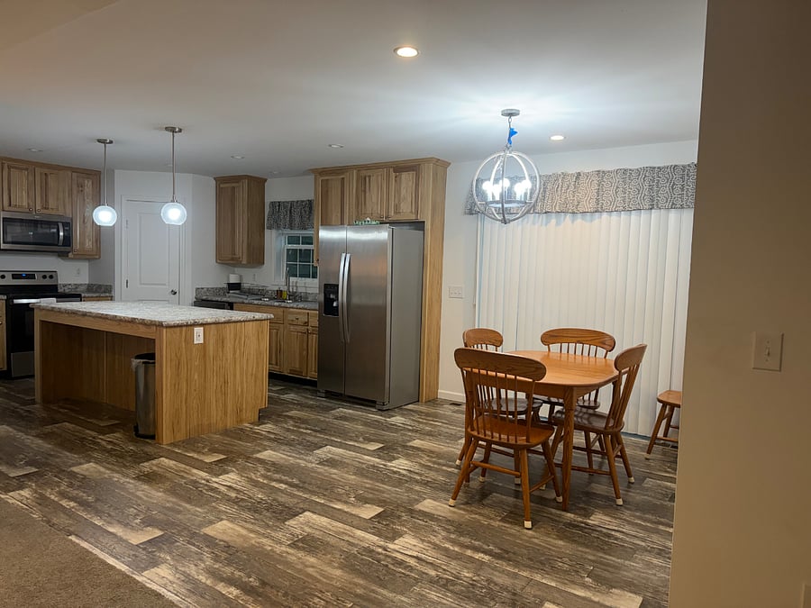 Kitchen and dining area with patio door (access to the deck).