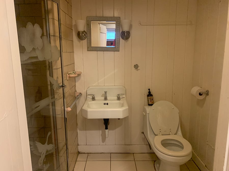 Old school bathroom with shower.