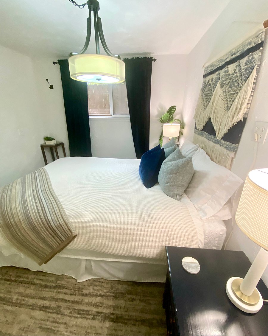 Large bedroom window looking over the stone path shade garden on the south side of the house. There are mini blinds as well as curtains to aid in a peaceful nights sleep.