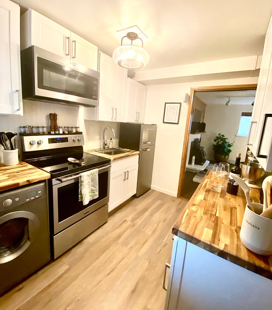 The kitchen separates the two living spaces; the studio/family room and the living room/dedicated bedroom/bathroom.