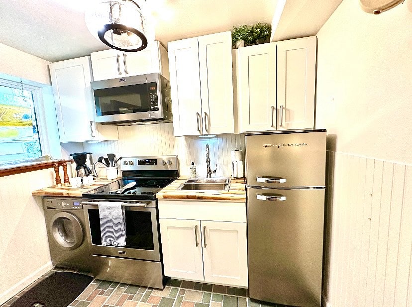 Small but mighty kitchen! With a non opening window allowing you to see whoever approaches the door.