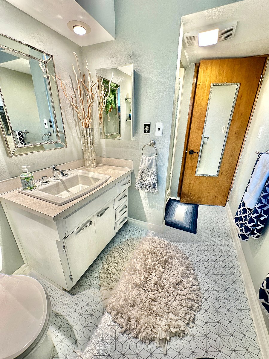 One bathroom with towels and starter supplies for your use. Heater fan and vent are just outside of the shower stall.