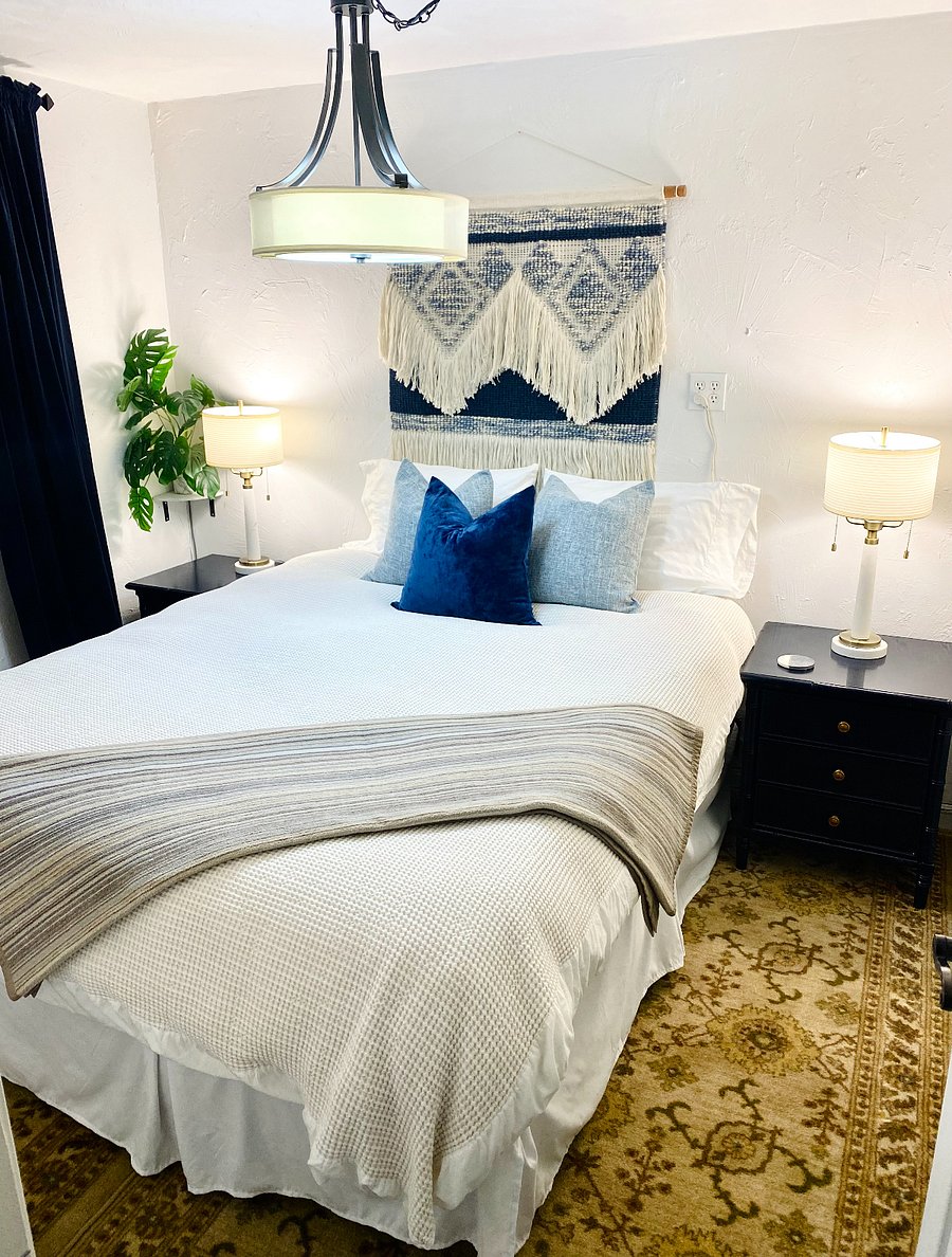 Queen size bed in the bedroom off of the TV/fireplace area. 