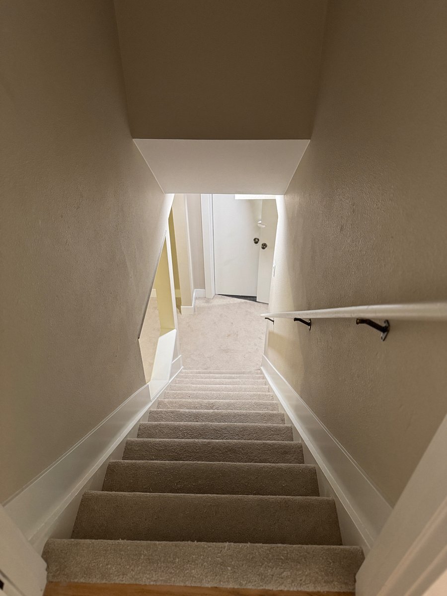 Stairway to rental space & shared laundry room.