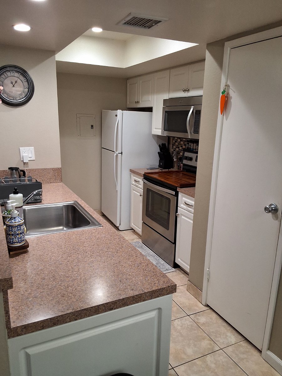 Kitchen with full size refrigerator, oven and microwave