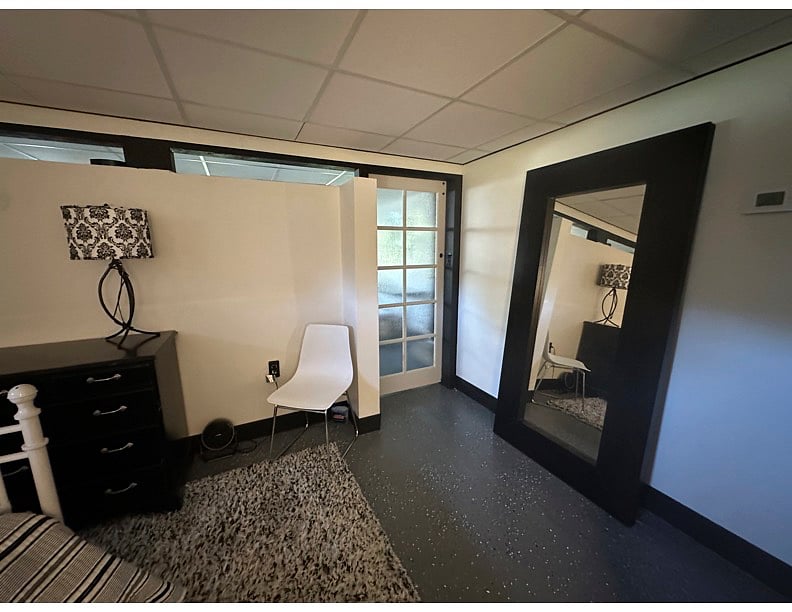Bedroom has large dresser, full length mirror and a lovely barn door.