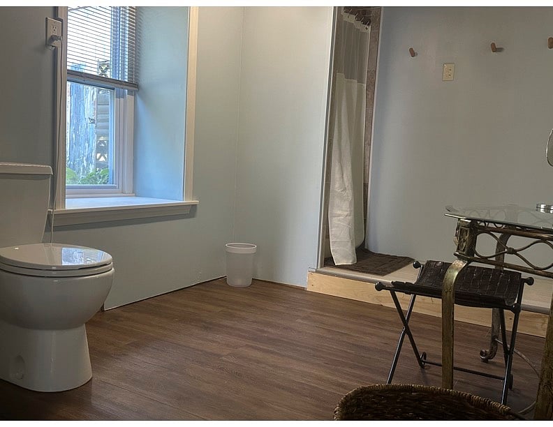 Full size window in bathroom offers plenty of light.