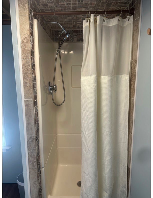 Shower stall with tile edging.