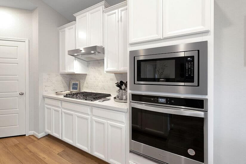 Kitchen with new stainless steel appliances.
