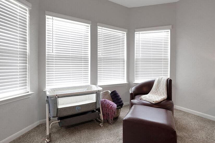 Crib and nursing chair for baby-friendly comfort.