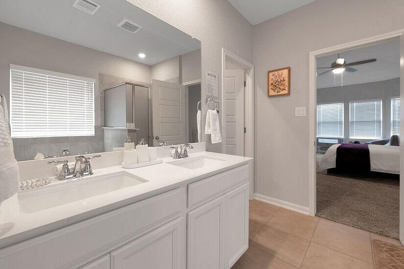Master bath with double sinks and private toilet room.
