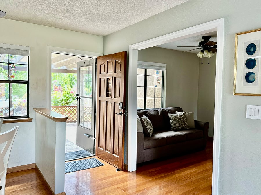 Lovely entrance with keyless front door entry, storm door, and open great room feel.