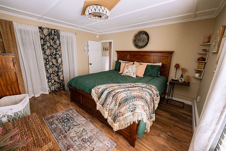 master bedroom with king-size memory foam mattress, blackout curtains, and spacious closet