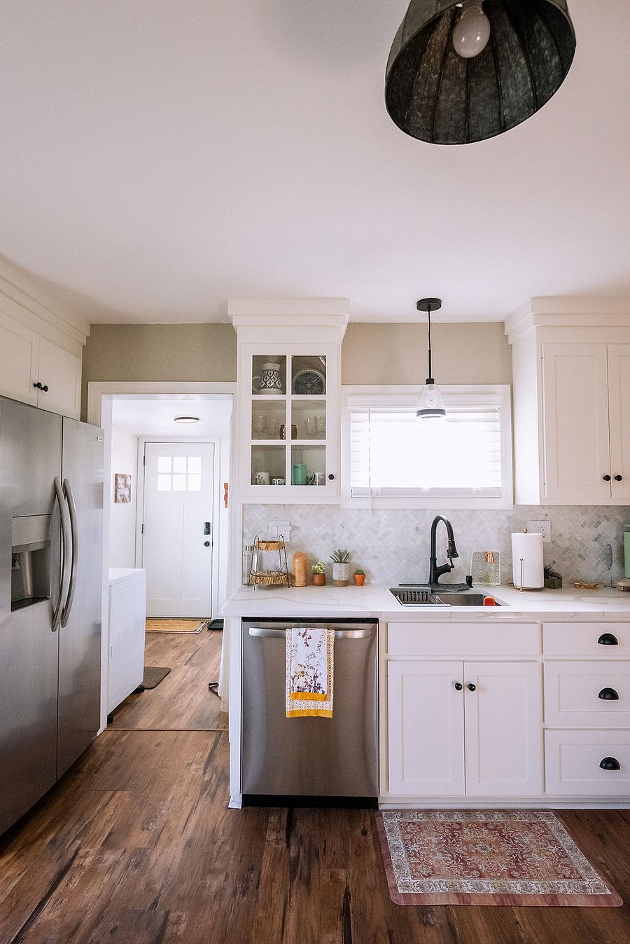 well-lit kitchen with full-size refrigerator
