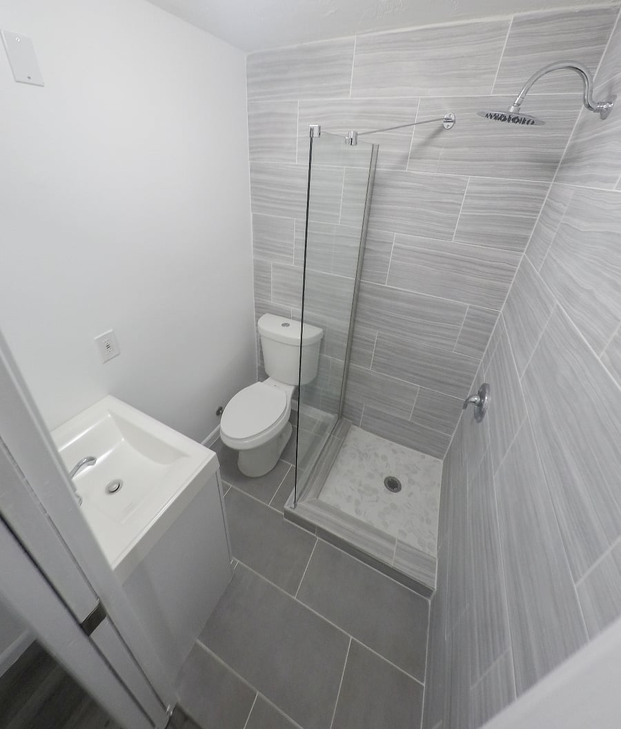 Bathroom in second bedroom. Shower, toilet and sink. 