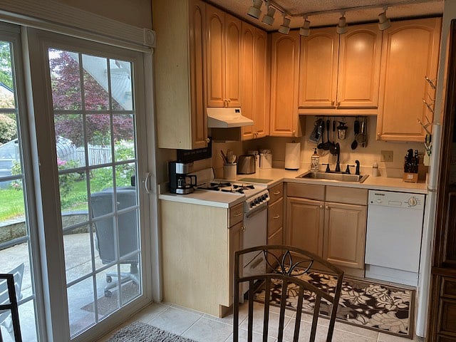 Kitchenette with gas stove, dishwasher, microwave, and refrigerator.