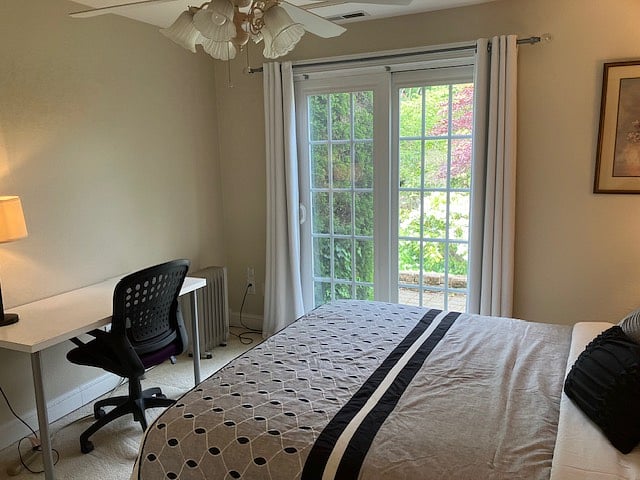 Desk area in Bedroom and sliding door to Private patio.