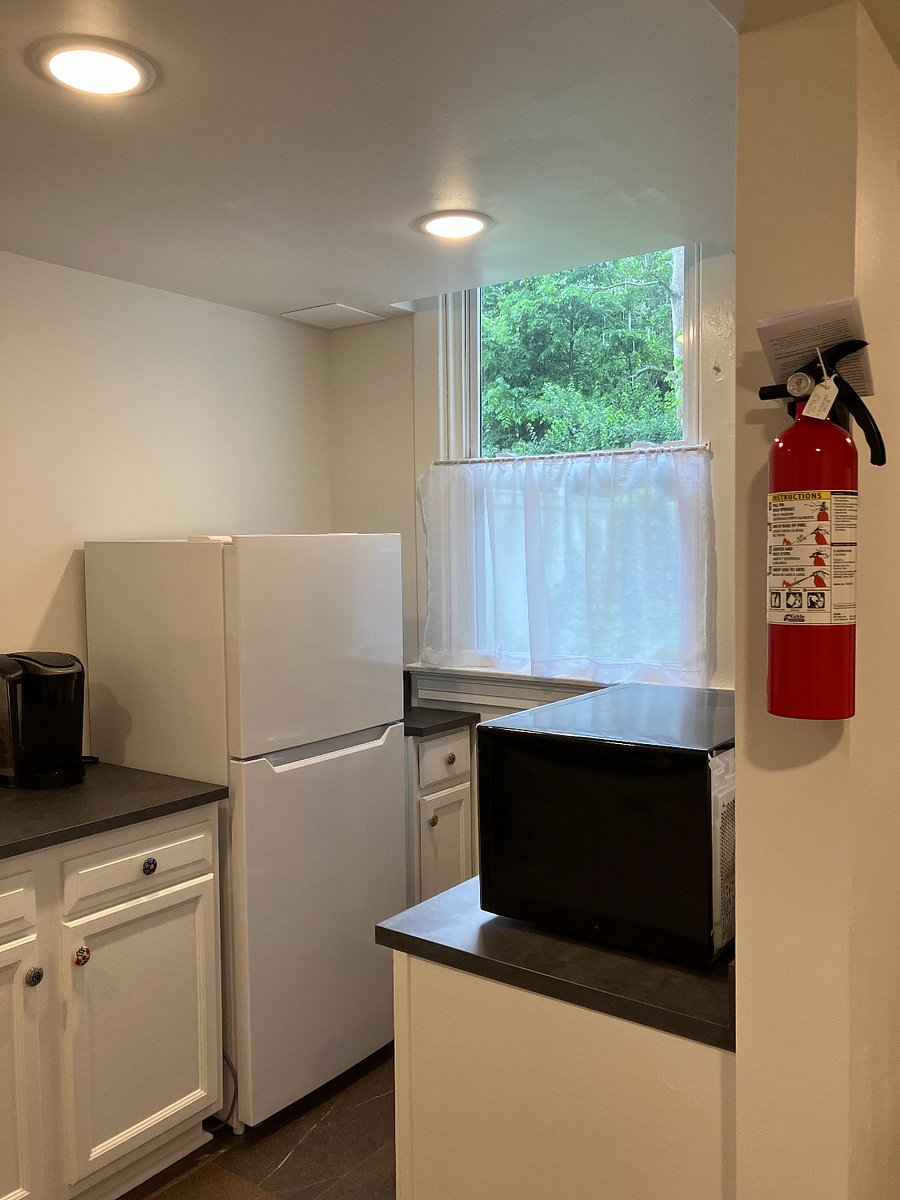 Medium sized fridge and a fire extinguisher for emergencies.
