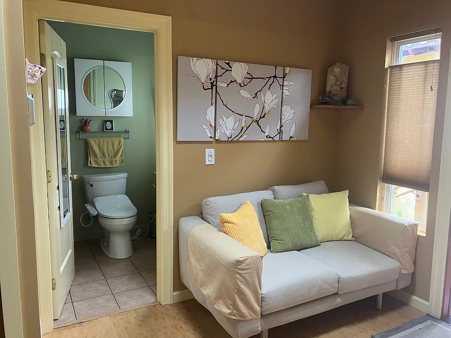 loveseat in entry room is opposite dining table