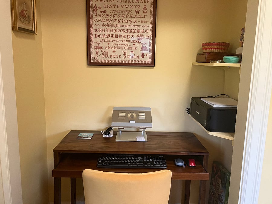 Desk alcove with external keyboard, mouse, adjustable laptop riser and printer. Chair is comfortable and adjustable