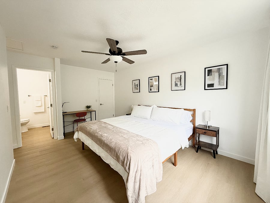 Bedroom 1: Master bedroom with king size bed, dedicated workspace, walk-in-closet, and private bathroom.