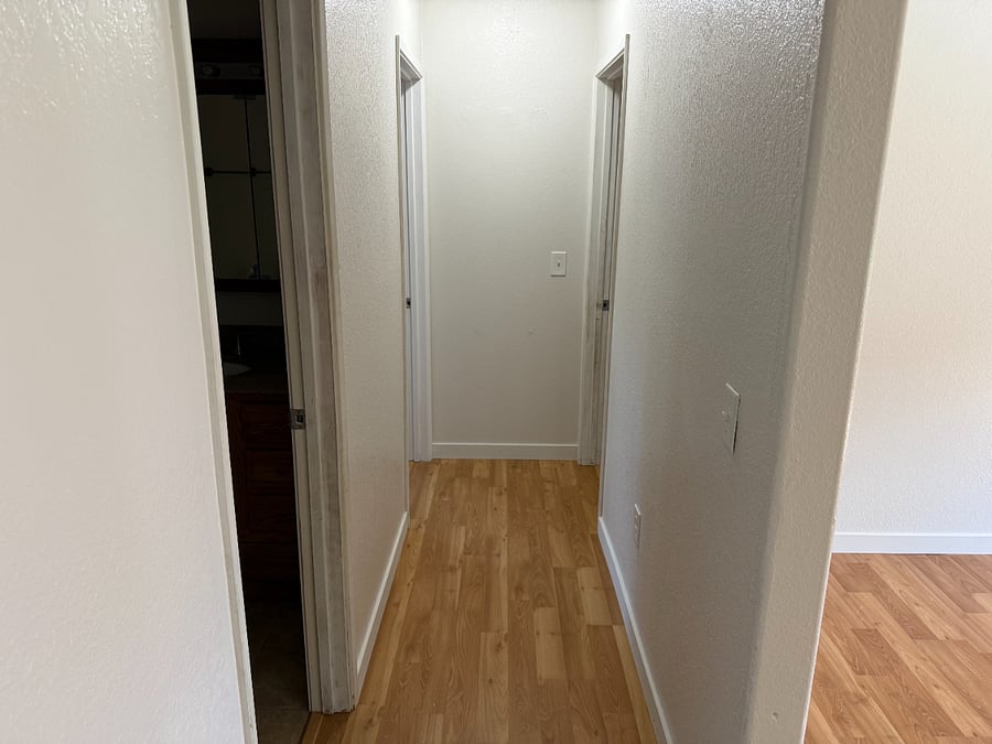 Hallway to 3 bedrooms and bathroom