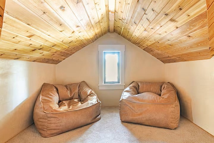 loft reading area with leather poofs.
