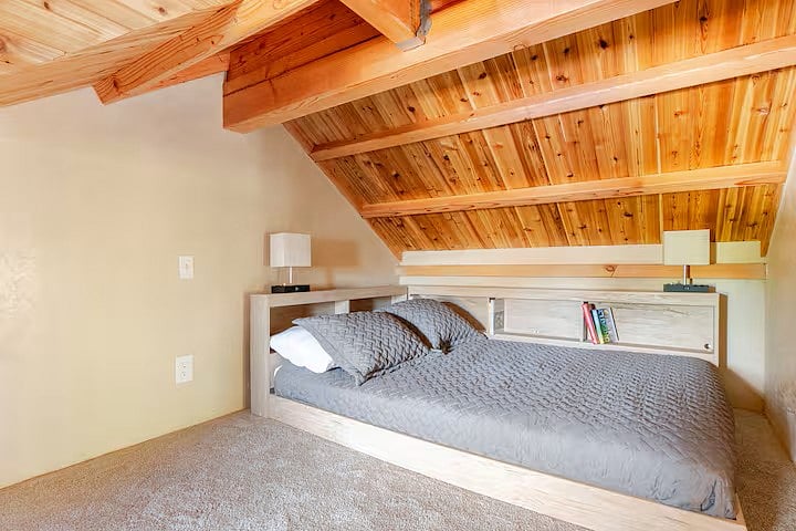 upstairs loft bed with built in bookshelves.