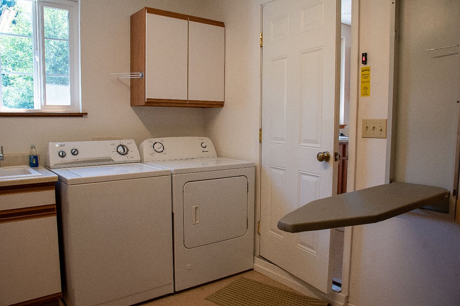 Laundry room with bult-in ironing board, sink and cleaning supply cupboard