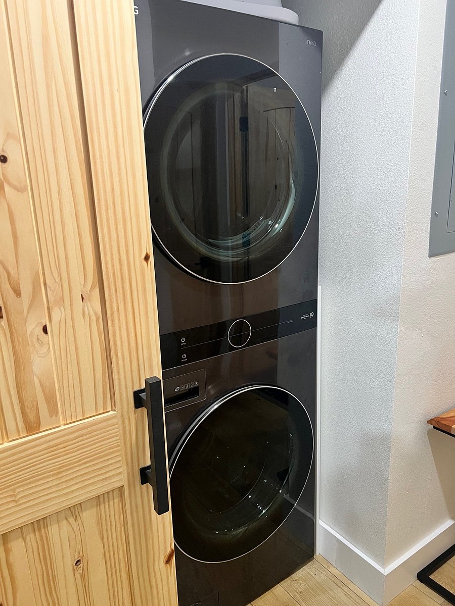 Stacked washer & dryer is right next to bedroom. Laundry detergent and softener provided.