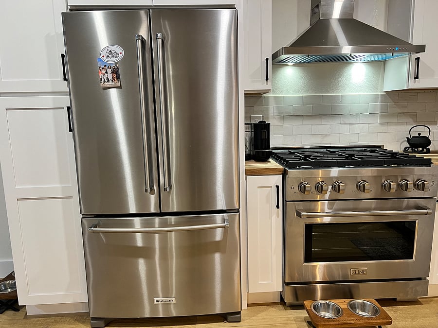 Kitchen Aid refrigerator and Z-Line, professional oversized gas stove and hood.