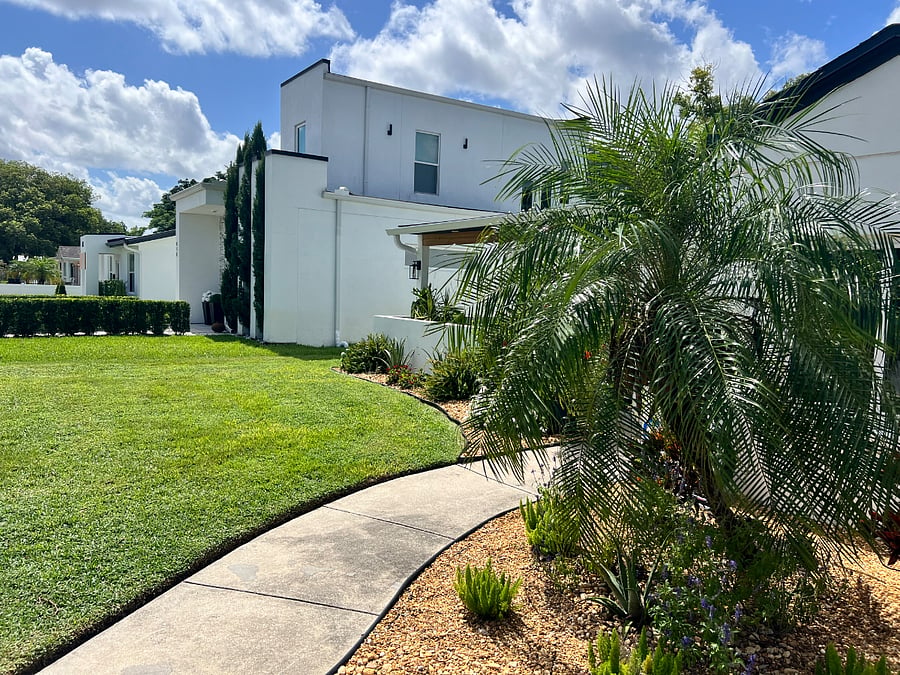 Friendly lawn care guy keeps up the maintenance while you kick back and enjoy the beautiful landscape. 