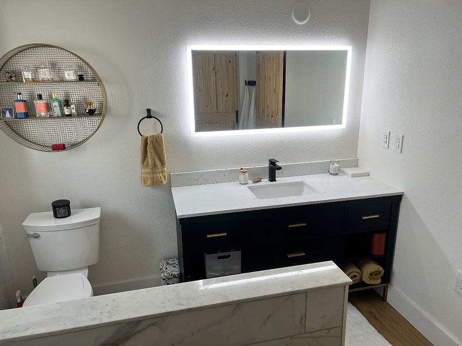 Touch-less illuminated lights and quartz top wooden vanity add luxury and appeal. 
