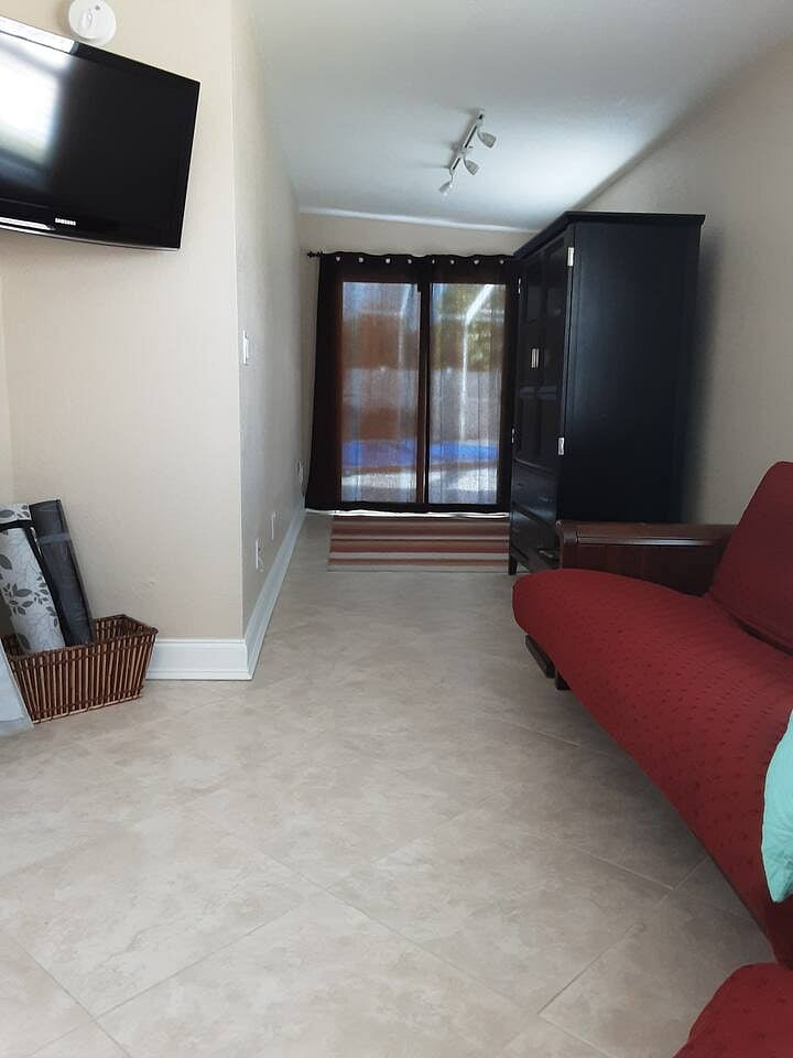 bedroom 4 has a smart tv and a pull out futon bed and chair.