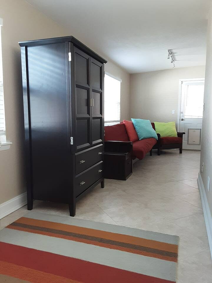 bedroom 4 has a smart tv and a pull out futon bed and chair.