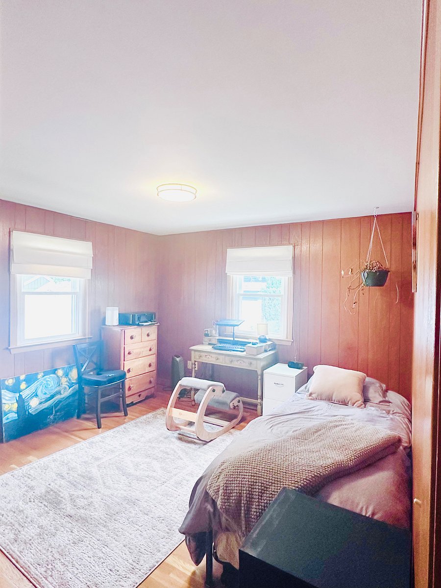Office and third bedroom - cloaked in warm wood paneling and bathed in sunlight. 

Whether working or resting, this space is ready to meet your needs. 