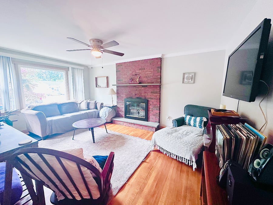 Living room with big screen, mounted Apple TV and comfortable seating.