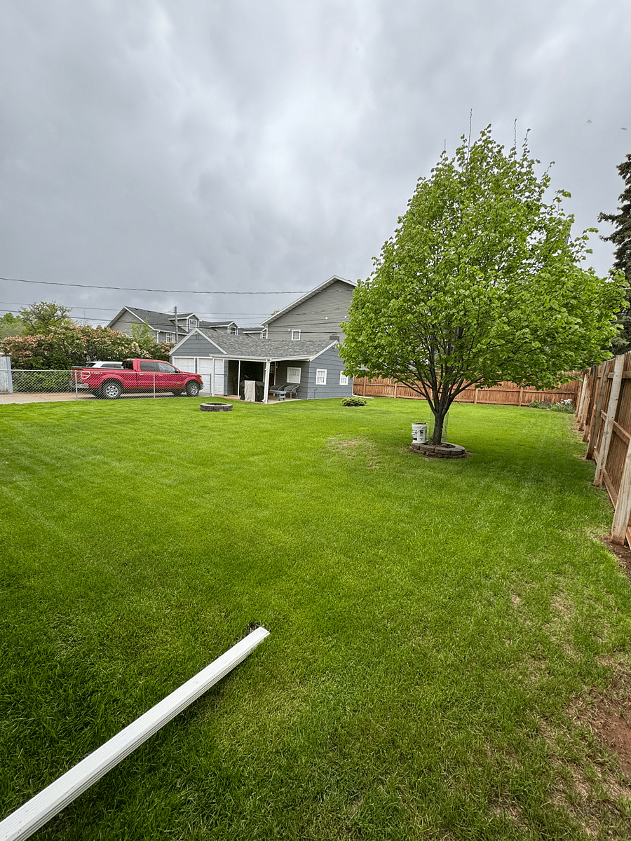 Large fenced in backyard with fire pit and free parking pictured